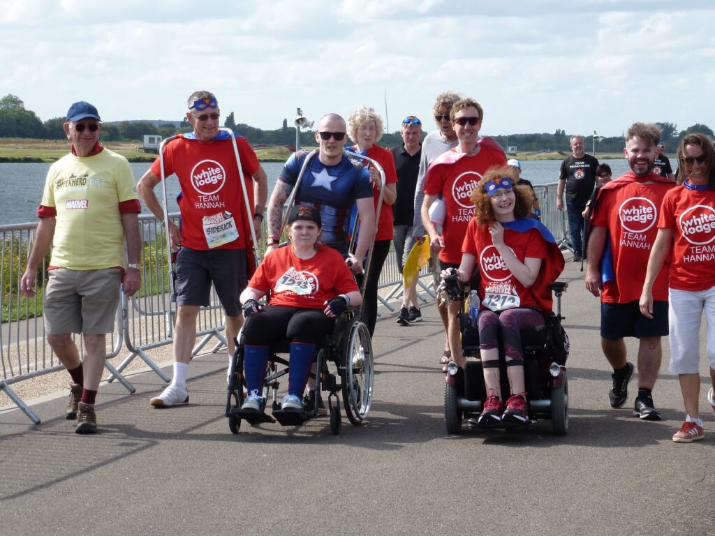 Team Hannah walking and wheeling up to the finish line of the Superhero Tri