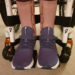 Hannah's purple/blue Nike Flyease Trainers perfect for SAFOs/ AFOs. Hannah has her SAFOs on with the shoes and you can see the edge of her wheelchiar she is sitting in.