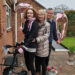 Hannah with her parents, after completing stage 1 of her #BenHannah3530 challenge. There is a big 3 and 0 balloon behind them in rose gold. They are smiling at the camera.