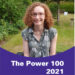 Hannah sitting in her powerchair in her garden. She is wearing a green dress with white flowers on it. There is a banner at the bottom of the photo which says 'The Power 100 2021' in white on a purple background.