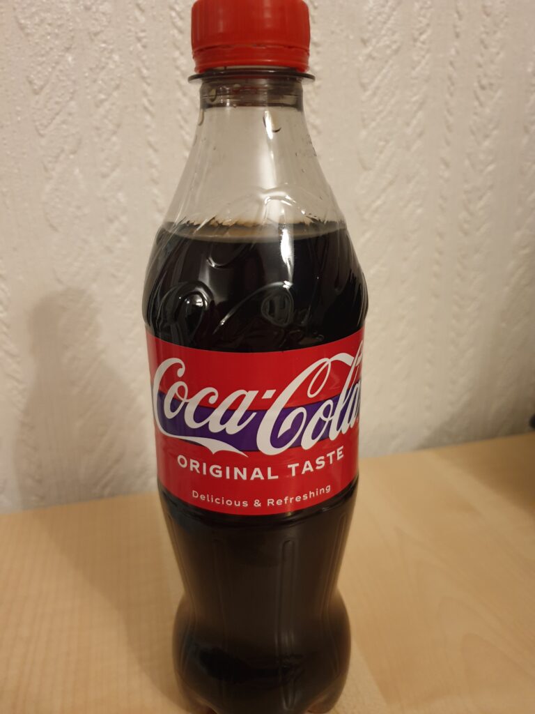 A Coca-Cola bottle with the purple band around the middle.