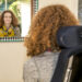 Hannah sitting in her powerchair looking at a reflextion of herself in the black, white and turquoise mosaic mirror thinking about what one think you wish non-disabled people knew or understood.