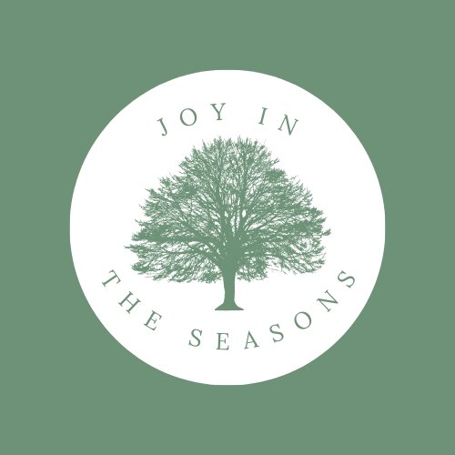 Joy In The Seasons logo which is a square with a green background. In the middle is a white circle with a green tree and the words: 'Joy In' above and 'The Seasons' below, also in green.