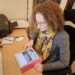 How To Start A Blog- Hannah looking at her blog on an iPad on the desk in front of her.