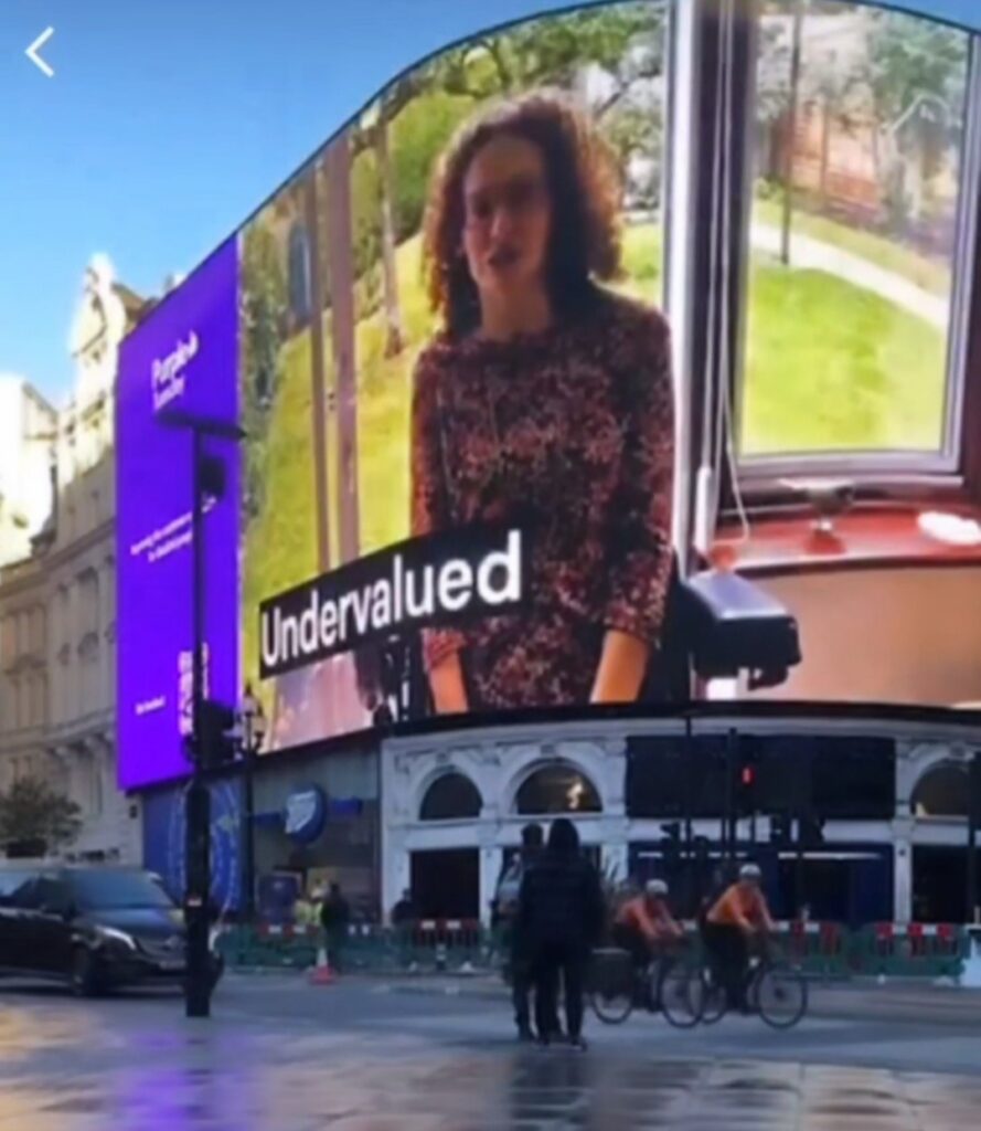 Hannah on Piccadilly Circus Lights witht the Purple Tuesday campaign saying how disabled consumers are often 'undervalued'.