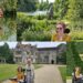 A collection of four photos, 2 of Sculpture by the lakes and 2 of Athelhampton House and gardens. Showing the lakes, house and gardens. It is all very green and lush. It is illustrating 2 Wheelchair Accessible gardens in Dorchester.