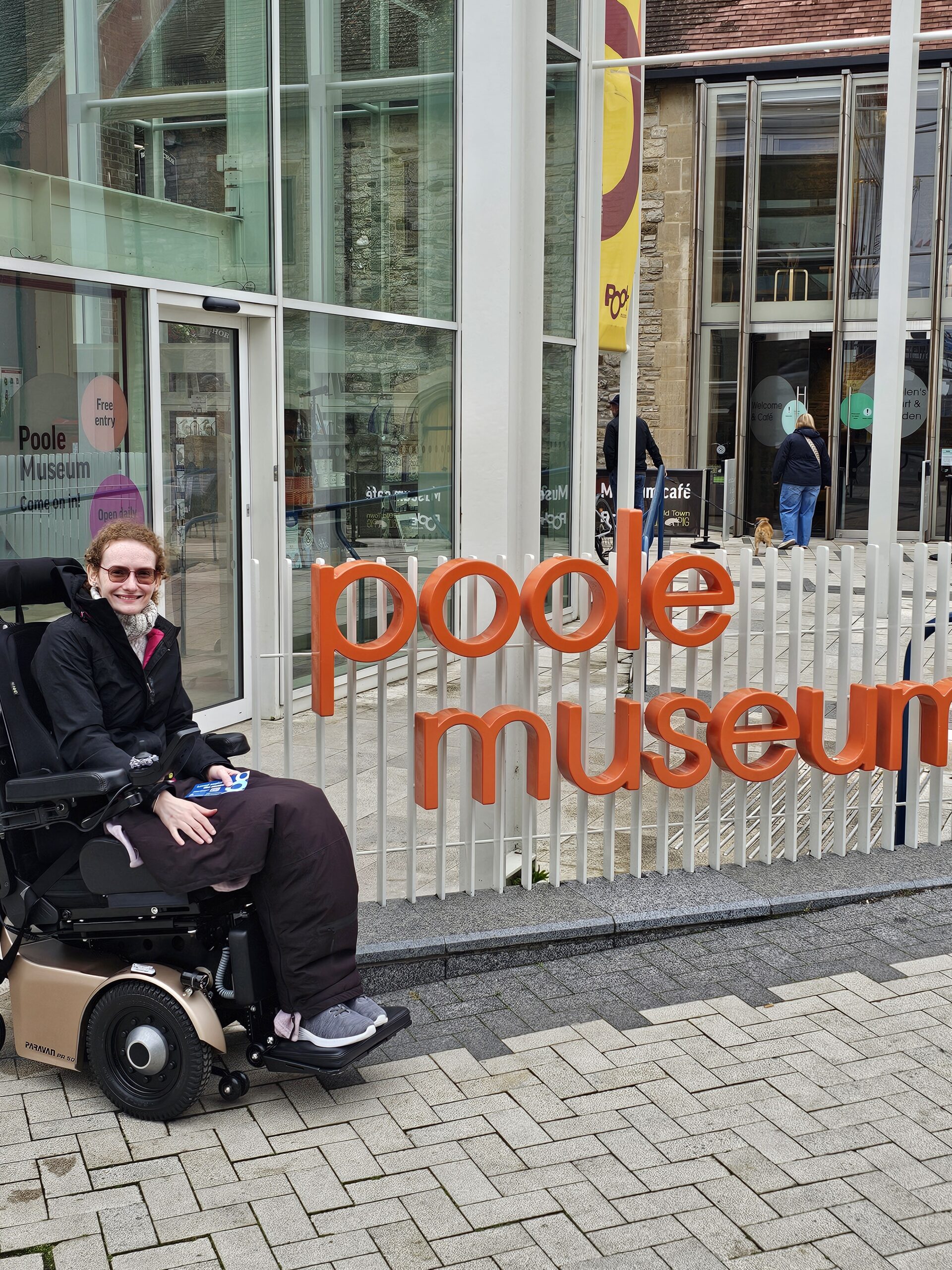 Hannah outside Poole museum. A wheelchair accessible place to visit around Poole.